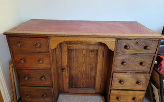 For sale: Antique oak kneehole desk with drawers.