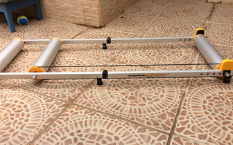 Action roller indoor cycle trainer